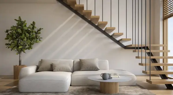 Nowoczesne schody otwarte na salon, z drewnianymi stopniami i metalową balustradą, tworzą lekkość i przestrzeń.